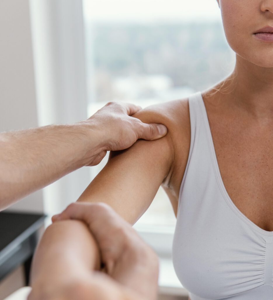 male osteopathic therapist checking female patient s shoulder 2