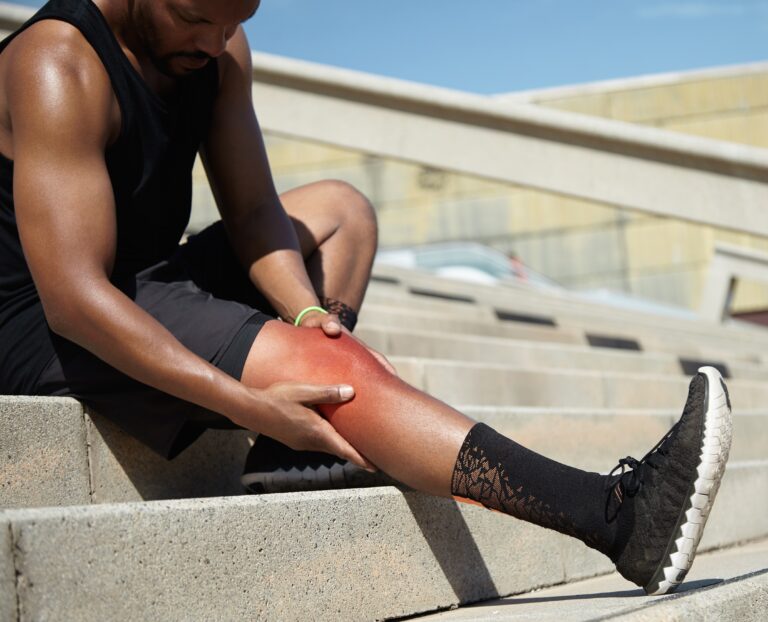 closeup young man with knee injury